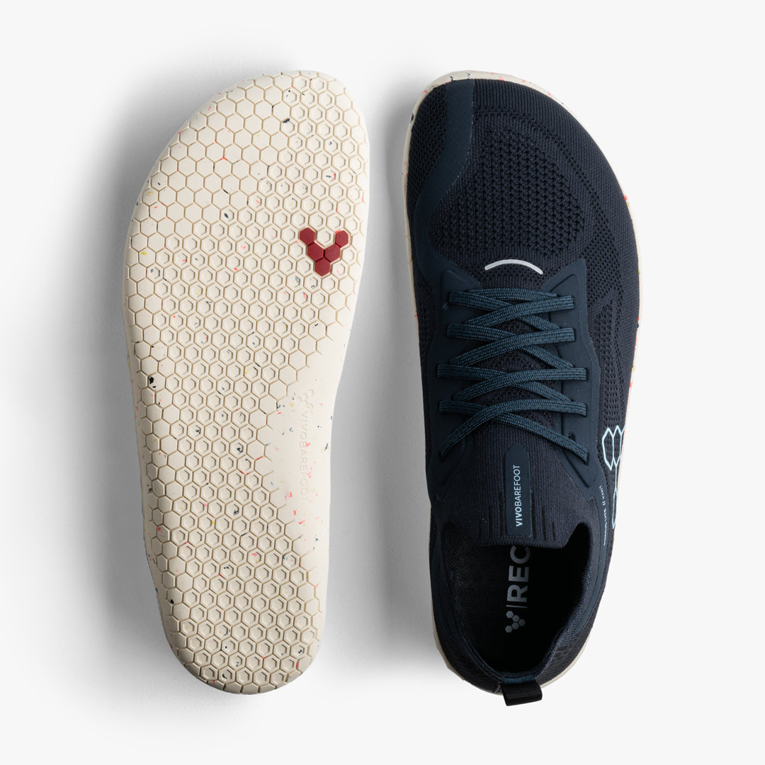 a pair of black knit Vivobarefoot minimalist shoes with the left side facing sole up